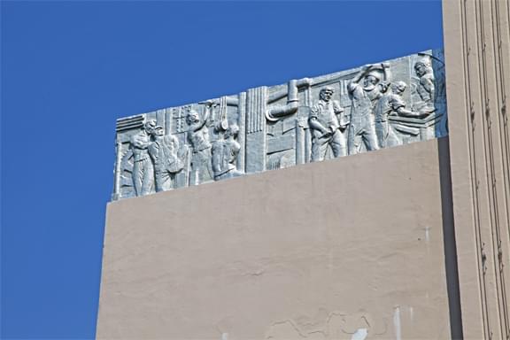 exterior wall stone carvings of men working