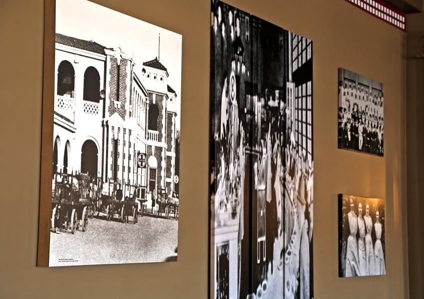historic photographs of building mounted on wall
